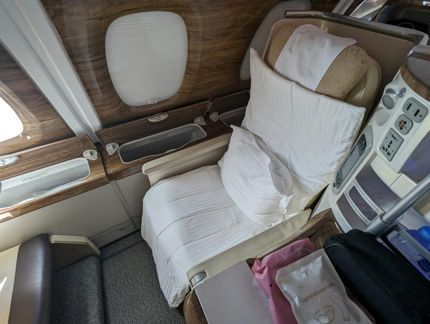 Lie-flat business class airplane seat converted into a bed on a long-haul flight