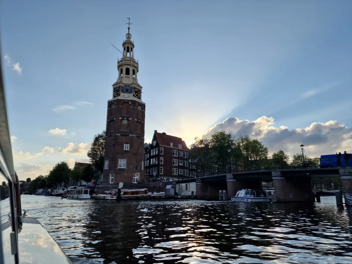 Amsterdam canal at sunset with a church tower, solo travel in the Netherlands
