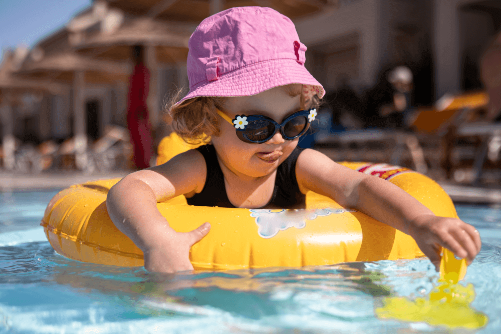Toddler in a safe, shallow pool at a family-friendly resort in Antalya — with lifeguard and shaded areas. A key feature of the best family-friendly resorts in Antalya