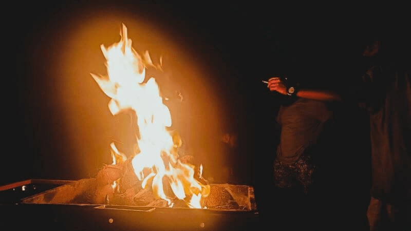 Bright flames from coconut shells burning in a grill during a beach barbecue in Sri Lanka