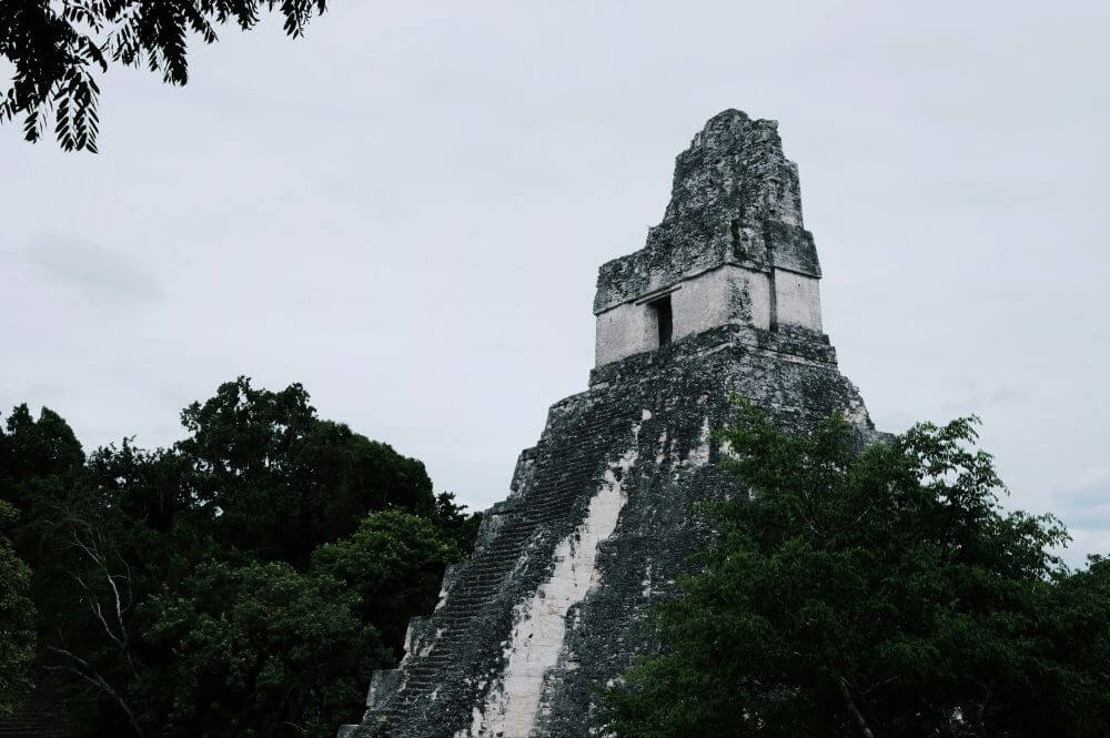 The Maya ruins of Tikal rise above the jungle — a reminder that Guatemalan cuisine is rooted in 3,000 years of tradition, not just modern recipes