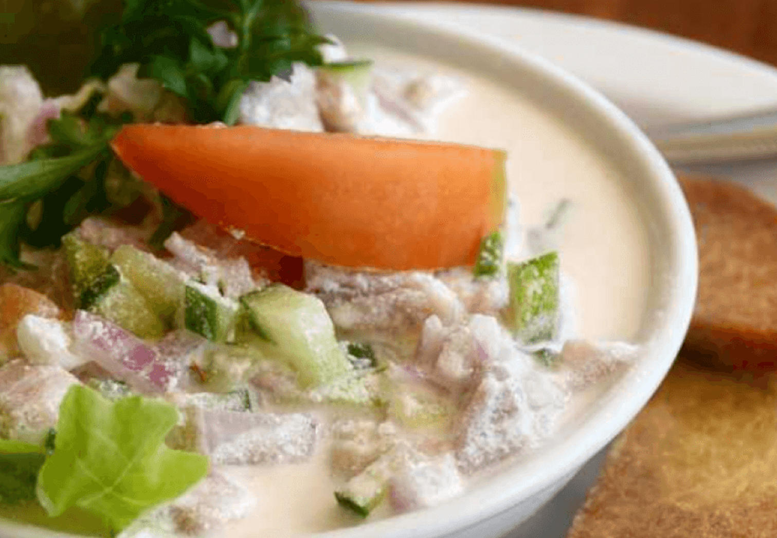 What do people eat in Kiribati: Ika mata served in a coconut shell with fresh vegetables and lime