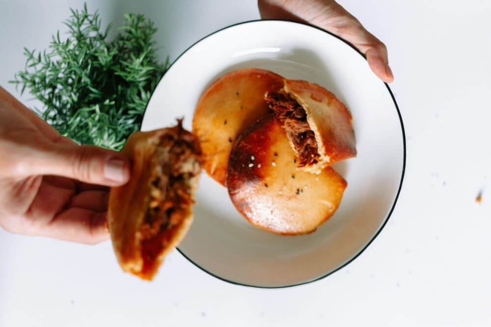 Sweet Korean hotteok pancakes filled with brown sugar — a warm, kid-friendly street food snack for families exploring Seoul"