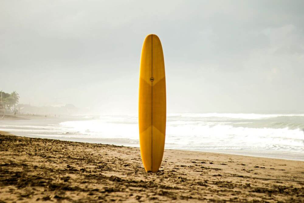 Classic longboard surfboard on sand — perfect for relaxed riding, nose rides, and heavier or taller surfers