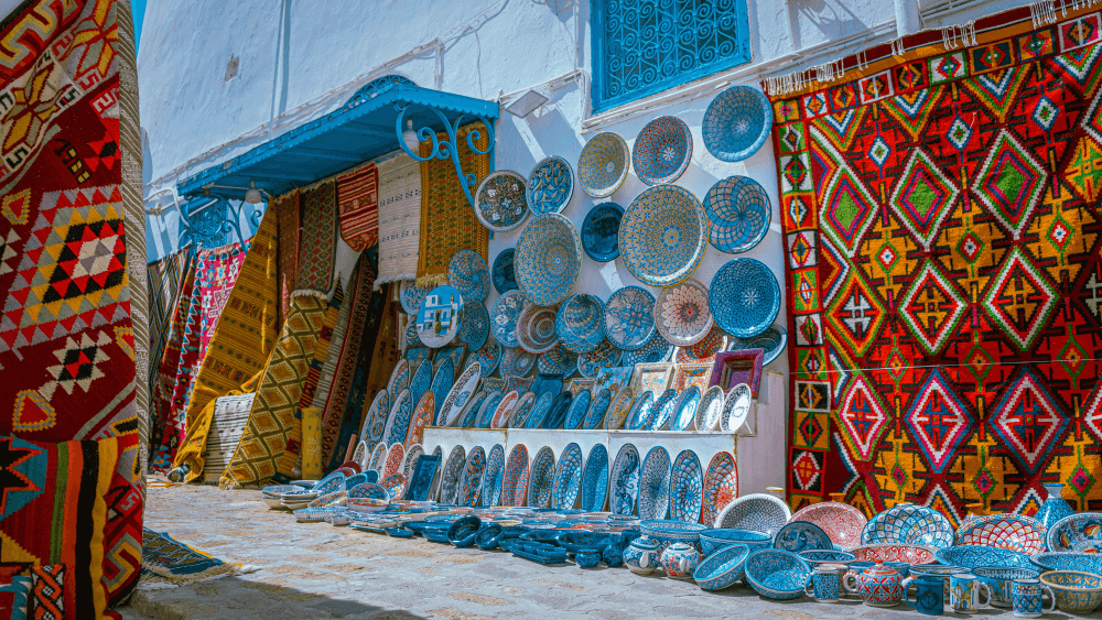 Free things to do in Marrakech: Traditional Moroccan crafts market with colorful rugs and pottery in the Medina