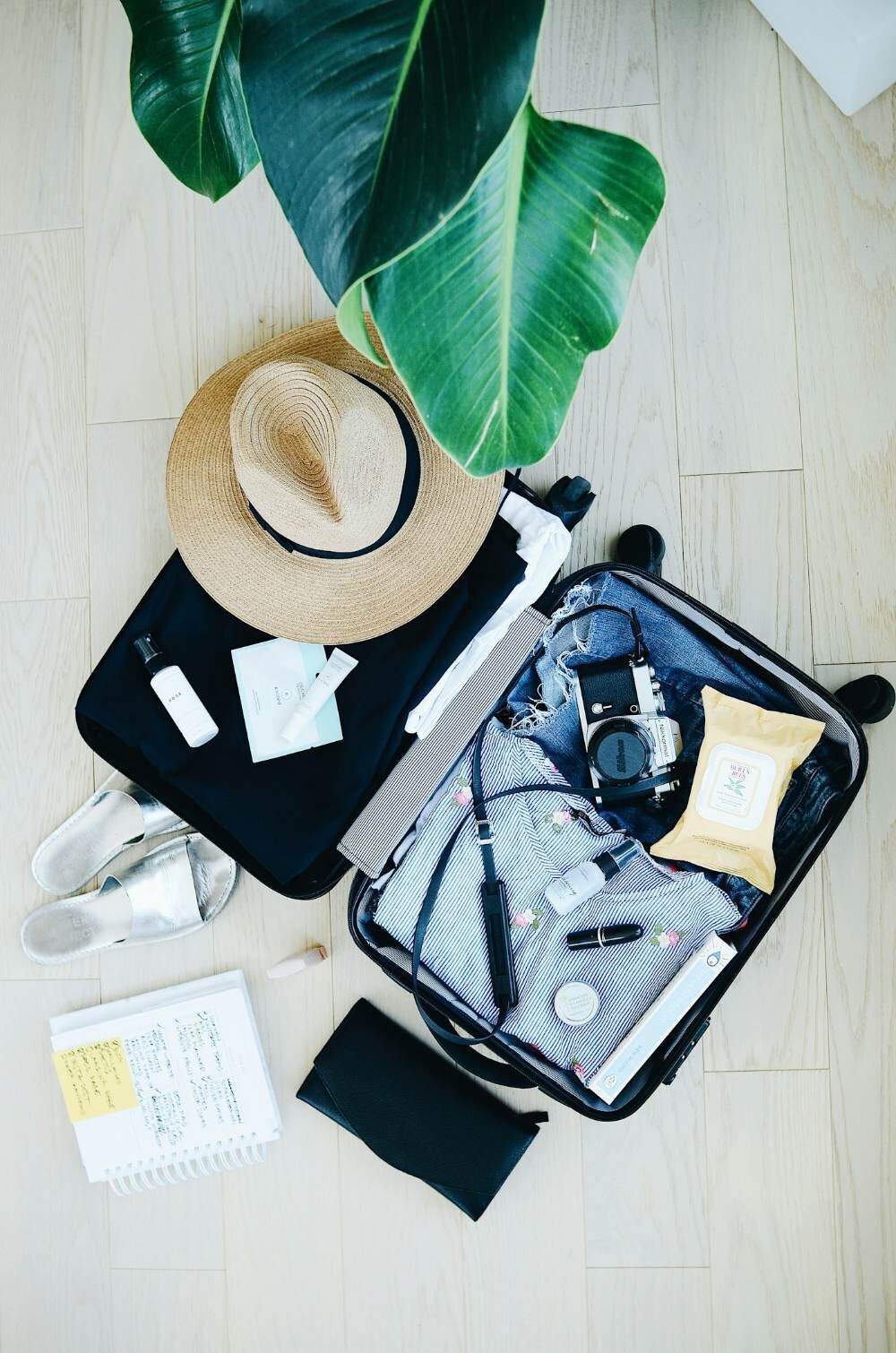 Open suitcase packed with clothes and travel essentials before a family trip