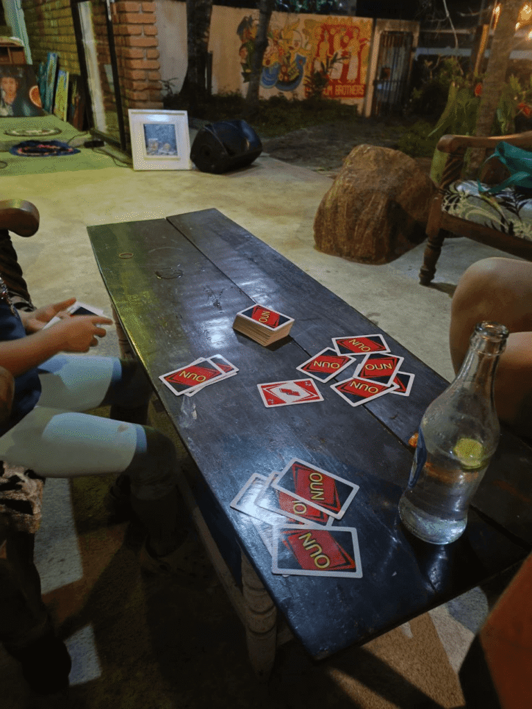 Playing UNO at the wooden table in Fat Burn Grill & Salads, Talalla — an ideal place for fun nights out