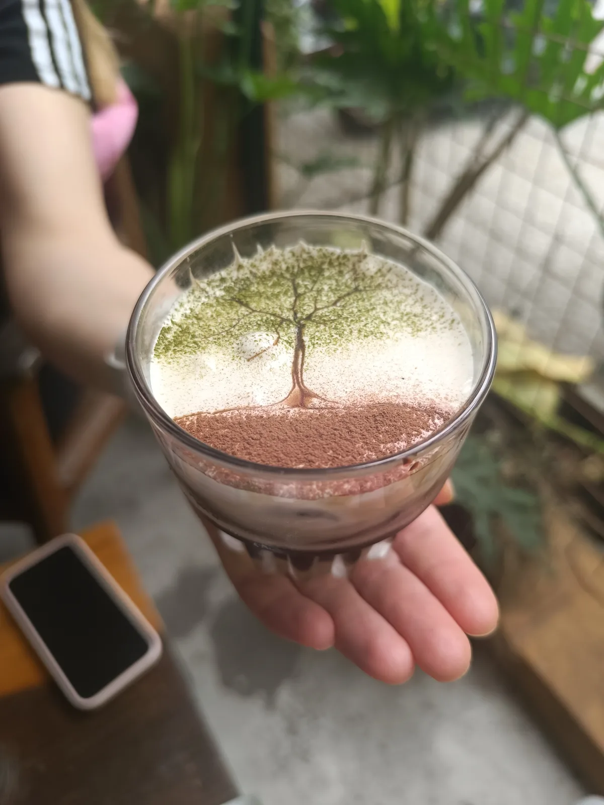 Vietnamese coffee with matcha at a tree-shaded café in Vietnam