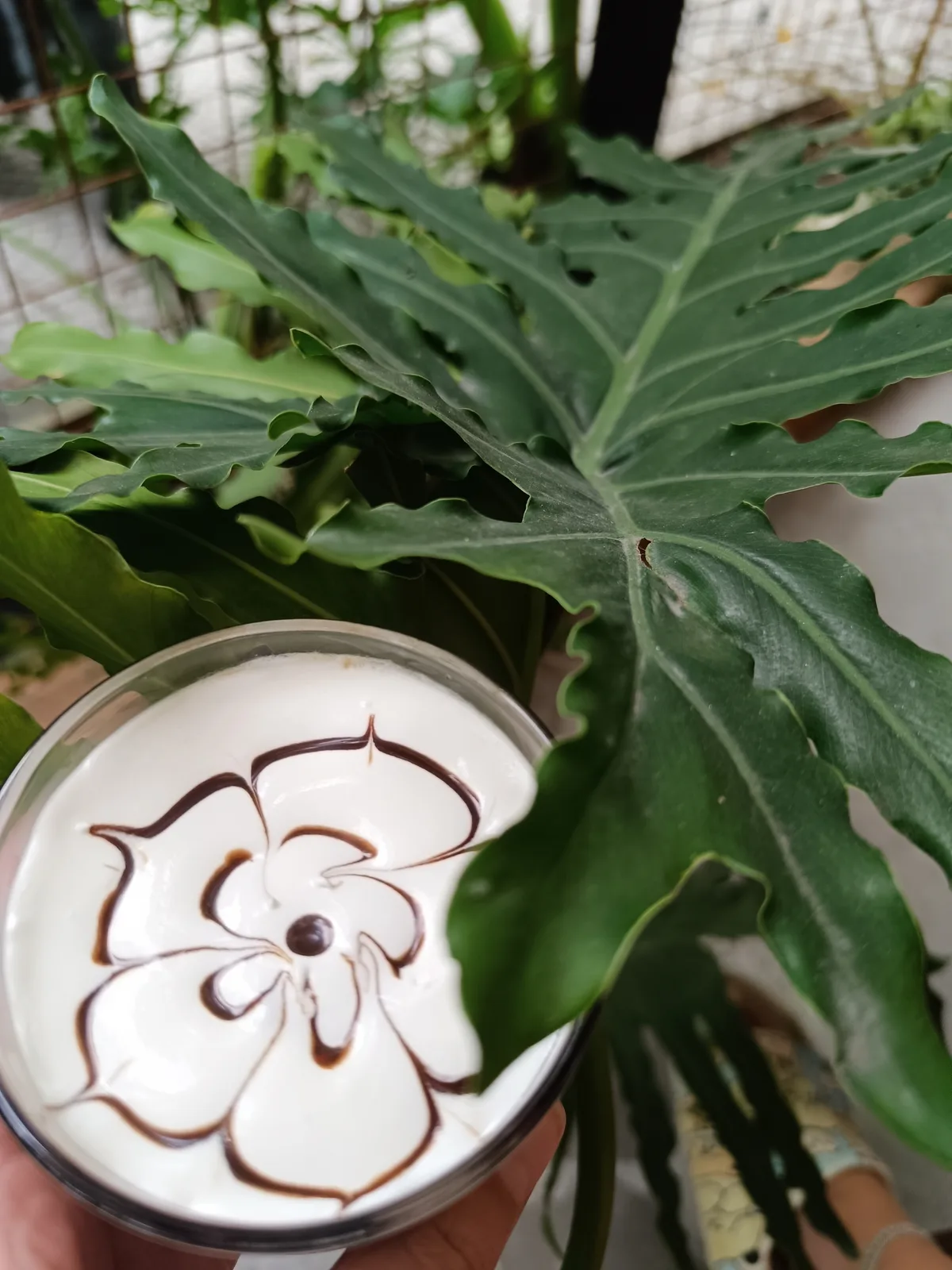 Beautiful latte art with flower and leaf design in a Vietnamese café